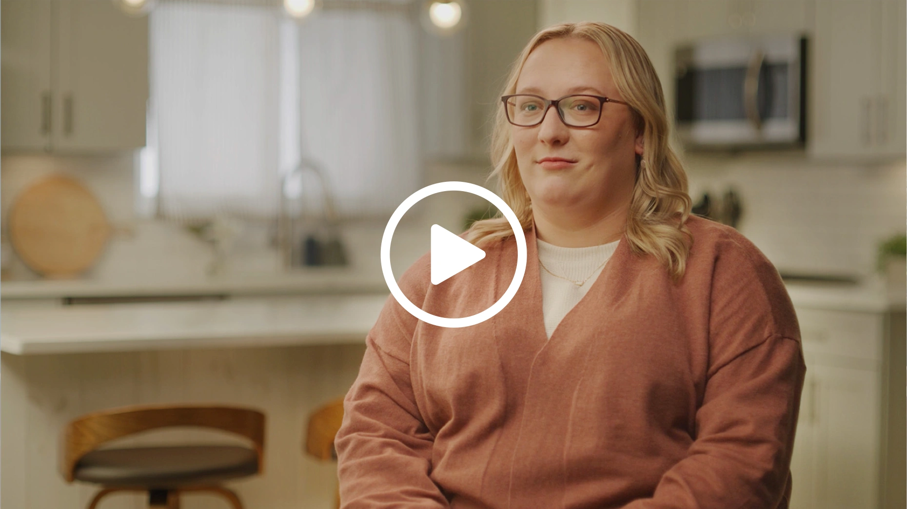 Woman in an orange shirt in the kitchen