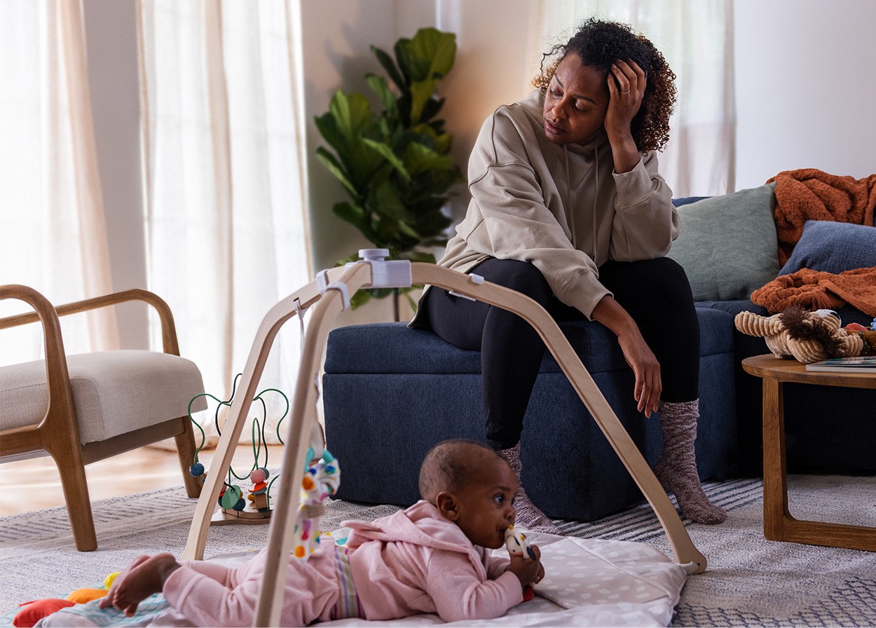 Woman sitting with baby in living room