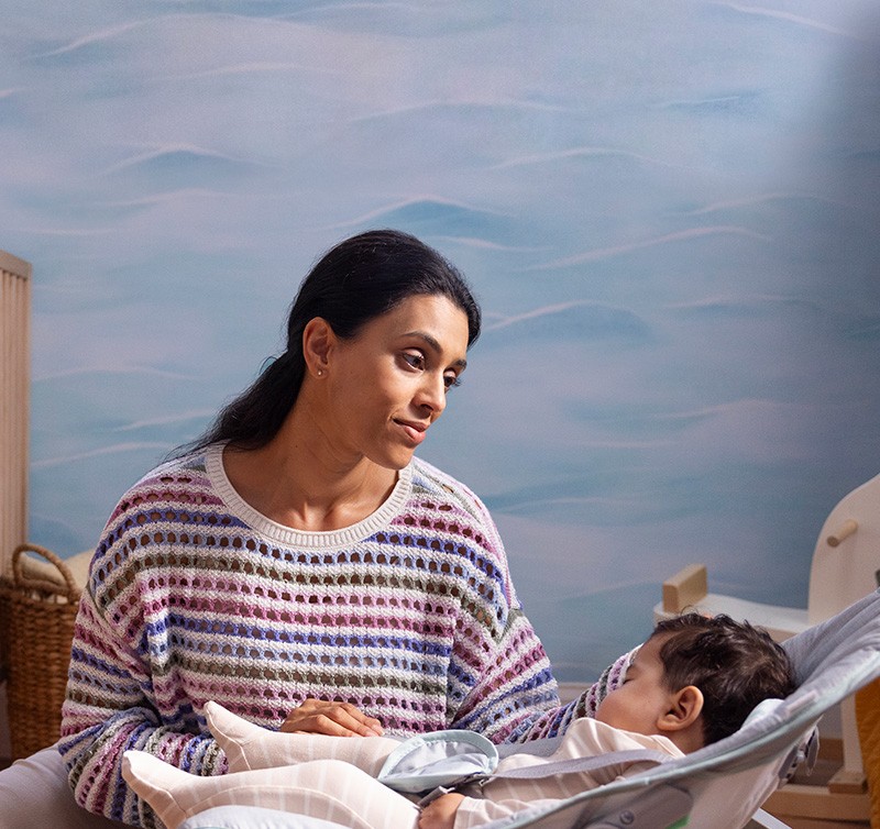 Woman in a nursery with her baby