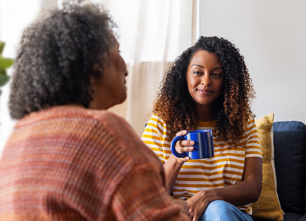 Woman holding coffee cup and smiling