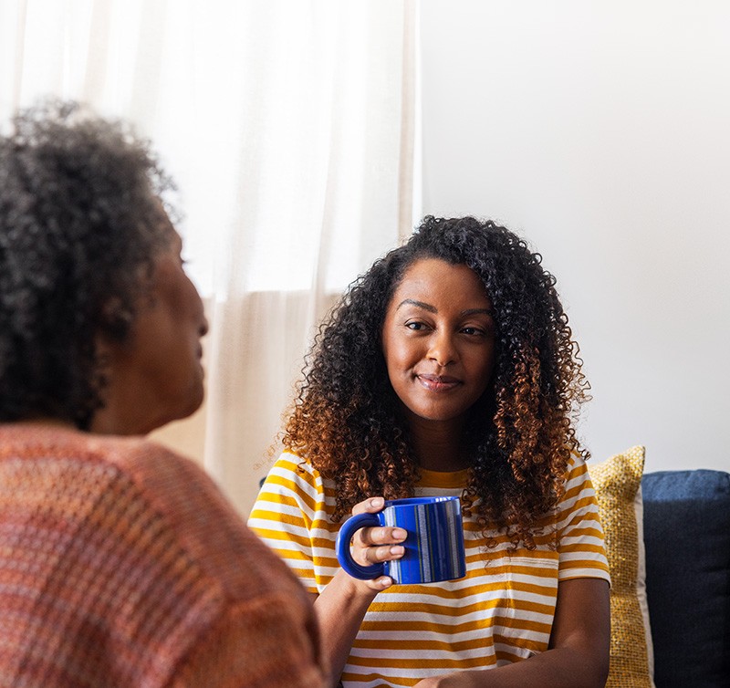 Woman holding coffee cup and smiling
