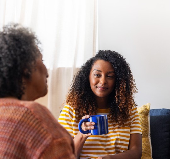 Woman holding coffee cup and smiling