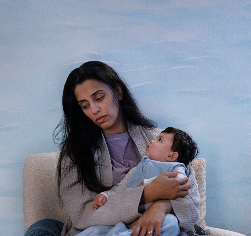 Woman in a living room with her baby